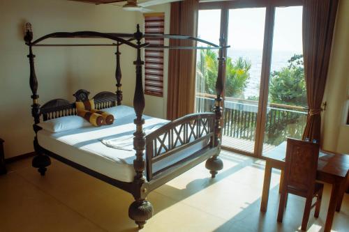 a bedroom with a bed with a view of the ocean at Dream Lagoon in Katunayake