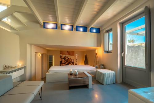a bedroom with a bed and a couch at 270 Oias View in Oia