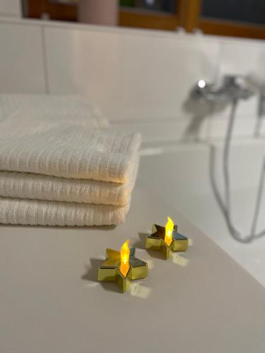 two yellow candles sitting on a bathroom counter at Haus Kleeblatt im Chiemgau in Siegsdorf