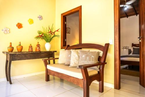 a room with a chair and a mirror at Pousada Campestre in Trancoso