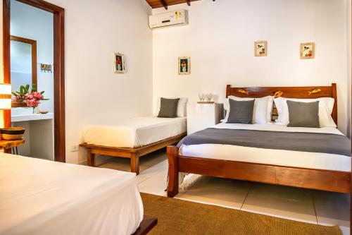 a hotel room with two beds and a window at Pousada Campestre in Trancoso