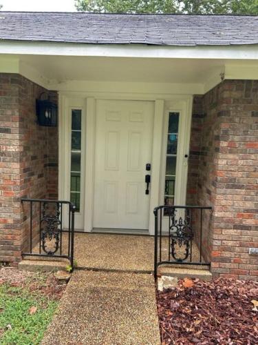 a front door of a brick house with a white door at Renaissance Rancher in Florence
