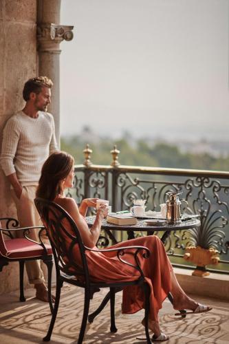 a man and a woman sitting at a table at Castillo Hotel Son Vida, a Luxury Collection Hotel, Mallorca in Palma de Mallorca