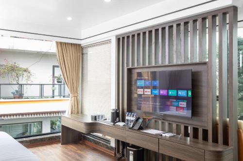 a hotel room with a large television in a room at Khách sạn Phố cổ Hotel Ninh Bình in Ninh Binh