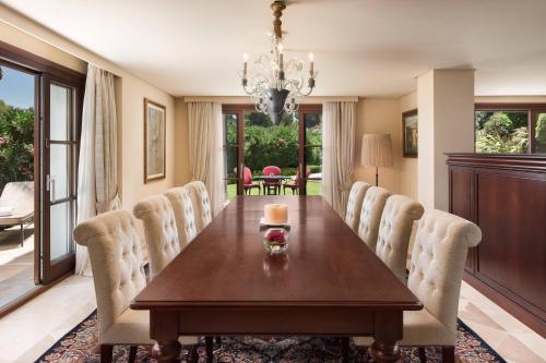a dining room with a wooden table and chairs at Castillo Hotel Son Vida, a Luxury Collection Hotel, Mallorca in Palma de Mallorca