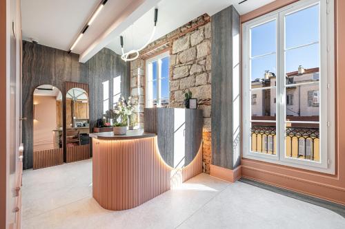 a large room with a counter in the middle of a building at Naomi Nice in Nice