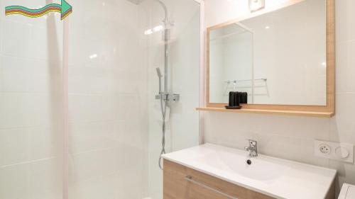 une salle de bain avec un lavabo et une douche avec un miroir dans l'établissement Residence du parc, à Luz-Saint-Sauveur