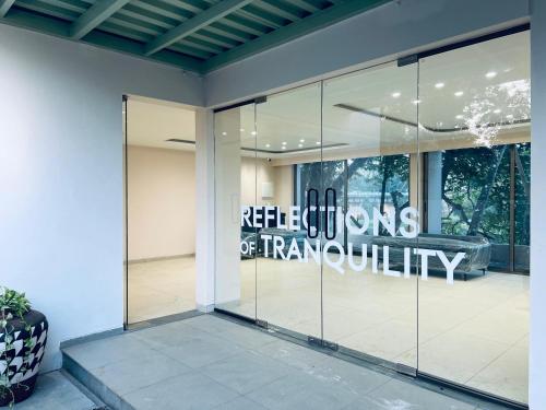 a glass door with a sign that reads reichenaming of firmquality at RIVERSCAPES by NOORJEHAN in Palakkad