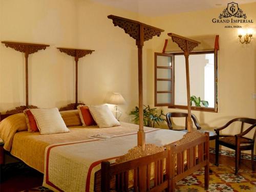 a bedroom with a large bed in a room at The Grand Imperial - Heritage Hotel in Agra