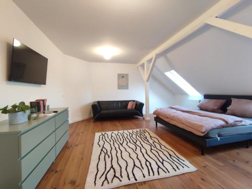 a living room with a bed and a couch at Apartment 58- Ruhr Nah in Essen