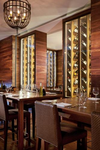 a dining room with a table and wine cellar at JW Marriott Indianapolis in Indianapolis