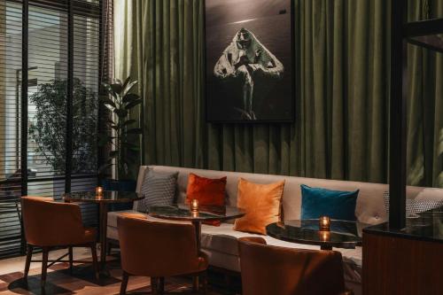 a living room with a couch and tables with pillows at The Santa Maria, a Luxury Collection Hotel & Golf Resort, Panama City in Panama City