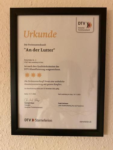 a diploma in a frame hanging on a wall at Ferienwohnung An der Lutter in Bad Lauterberg