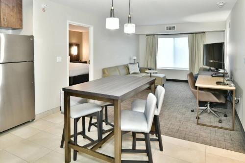 a kitchen and living room with a table and chairs at Residence Inn by Marriott Eau Claire in Eau Claire