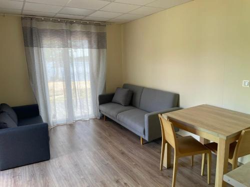 a living room with a couch and a table at Chatka Raju in Wąsosz