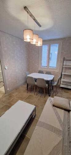 a living room with a white table and chairs at S-e-r-a-l-y 1 in Égliseneuve-dʼEntraigues
