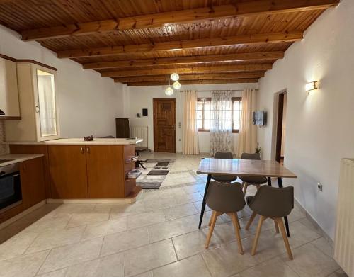 a kitchen and dining room with a table and chairs at Koutsogiannopoulos House in Kalavrita