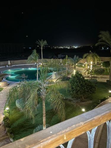 a view of a swimming pool at night at Al Saraya Sahl Hashish Serenity Chalet in Hurghada
