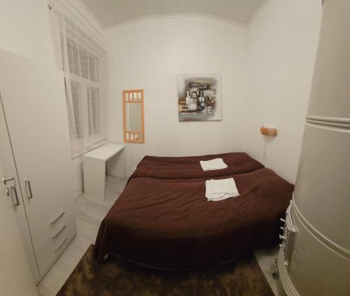 a bedroom with a bed with two towels on it at Ilona Vanha Rauma in Rauma