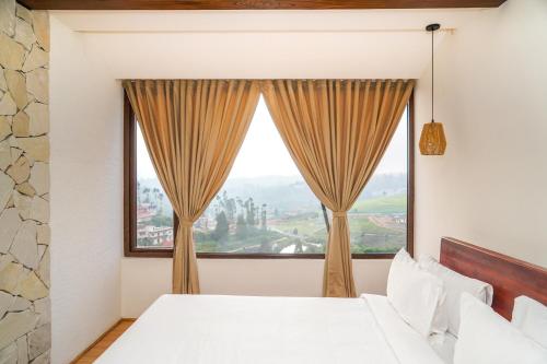 a bedroom with a large window at Virgin Valley Leisure Resort in Ooty