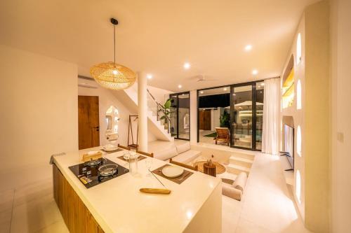 a kitchen and living room with a island in a house at Villa Somnia Bliss Private One Bedroom Retreat in Tumbak Bayuh