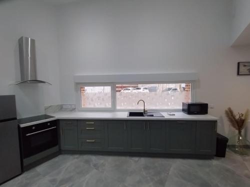 a kitchen with a sink and a window at Maison individuelle centre ville "TIMAJO" in Bapaume