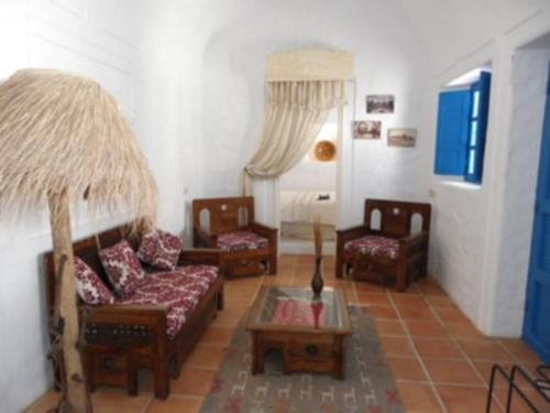 a living room with couches and chairs and a table at L'autre dar in Houmt Souk