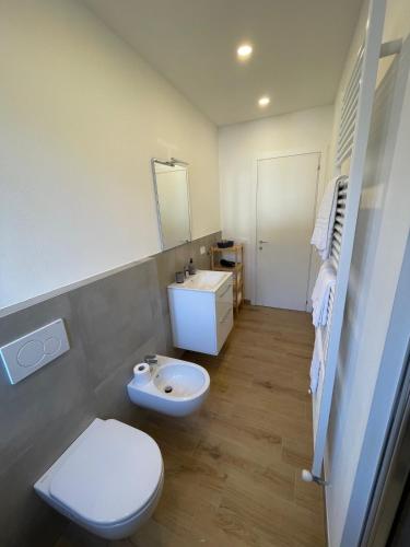 a bathroom with a white toilet and a sink at Cà Rosetta in Ornavasso