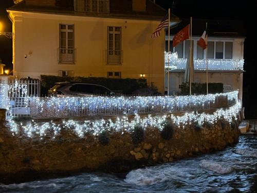 a fence with christmas lights in front of a building at LE 41 AVENUE FOCH in Luchon