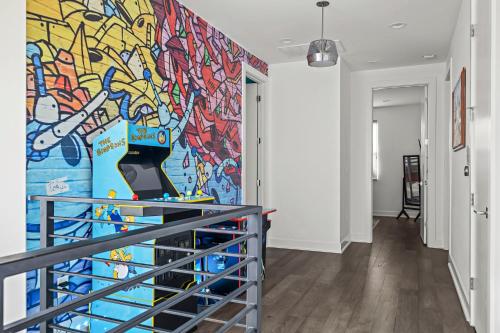 a hallway with a colorful mural on the wall at Stylish 4BR with Infrared Sauna, Hot Tub, Cornhole and Cowboy Pool in Austin