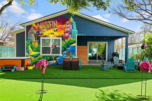 a house with a mural on the side of it at Stylish 4BR with Infrared Sauna, Hot Tub, Cornhole and Cowboy Pool in Austin