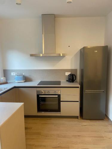 a kitchen with a stainless steel refrigerator and cabinets at Cà Marina in Ornavasso