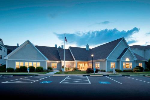 a building with a parking lot in front of it at Residence Inn New Bedford Dartmouth in North Dartmouth