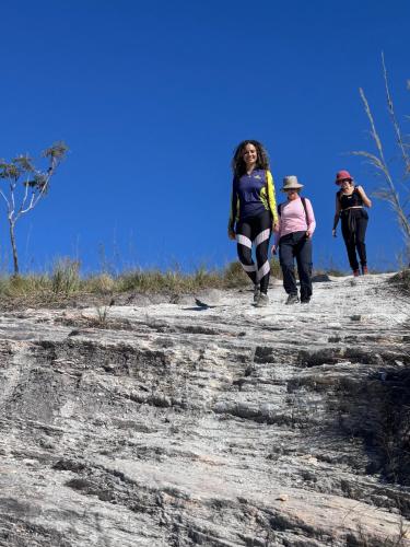 a group of people walking up a rock formation at Casa Matutina Colonial-Conforto Moderno no Centro Histórico in Pirenópolis