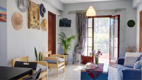 a living room with a couch and a table at Skaros House in Agios Georgios Pagon