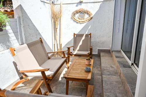 two chairs and a table on a balcony at Hotel La Tuiliere in Carry-le-Rouet