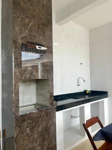 a kitchen with a sink and a counter at Suitella in Cabo Frio