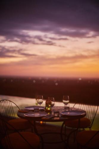 a table with three wine glasses sitting on top of it at Dar Imiri in Ourika