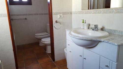 a bathroom with a sink and a toilet at Exclusively located Golf Villa with heated pool in San Miguel de Abona