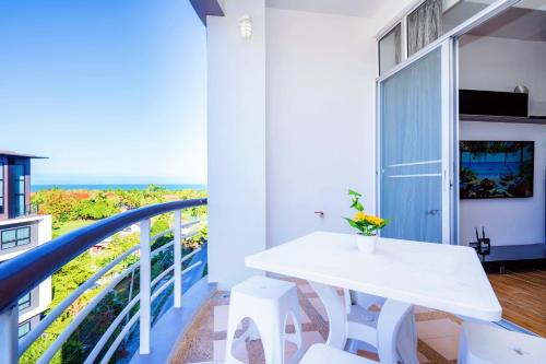 a white table and white chairs on a balcony at Hua Hin First-Hin Nam in Hua Hin