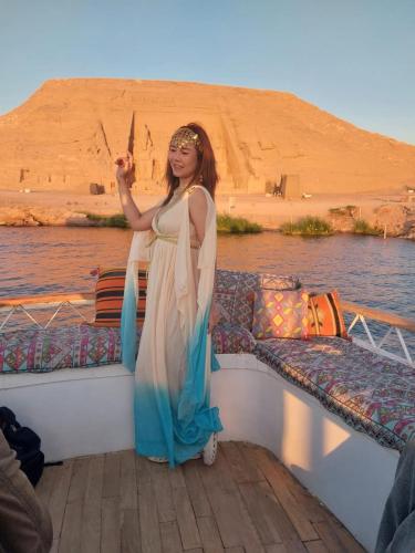 a woman standing on the side of a boat at Summer Land Hotel in Abu Simbel