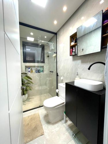 a bathroom with a toilet and a sink and a shower at Cobertura Amanhecer em Dois Irmãos in Dois Irmãos