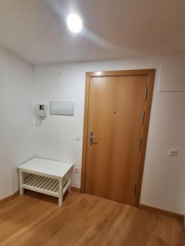 an empty room with a door and a table at EscarraSuite in Escarrilla