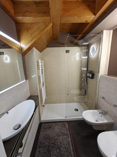 a bathroom with a tub and a sink and a shower at Hotel La Thuile Resort & SPA in La Thuile