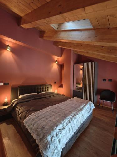 a bedroom with a large bed and a wooden ceiling at Hotel La Thuile Resort & SPA in La Thuile