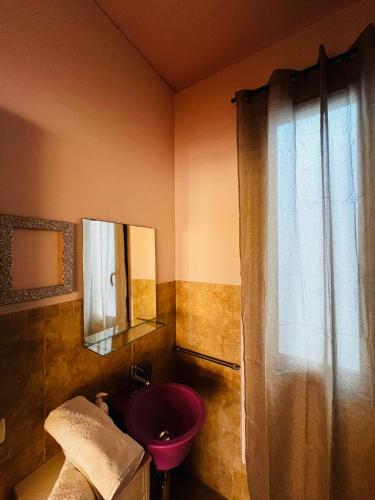 a bathroom with a pink sink and a shower at Sicilia Vacation rooms in Trapani