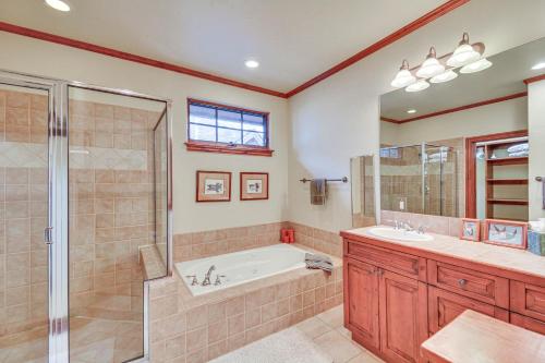 a bathroom with a tub and a shower and a sink at Cozy Avon Retreat w/ Private Deck & Pool Access! in Avon