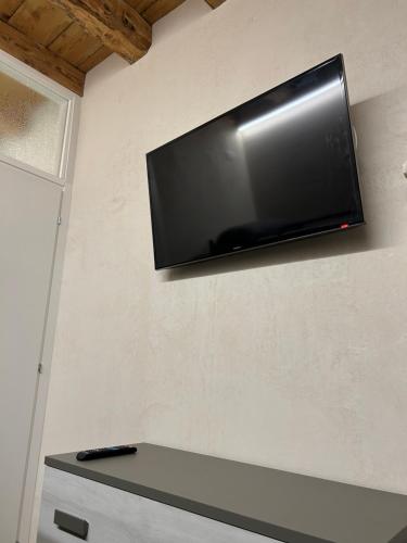 a flat screen tv hanging on a wall at Larocca Tourist Home 1 Valbrenta in Carpane