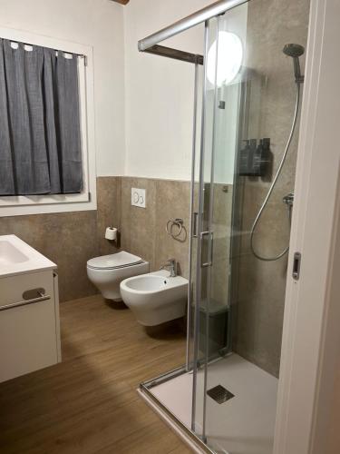 a bathroom with a shower and a toilet and a sink at Larocca Tourist Home 1 Valbrenta in Carpane