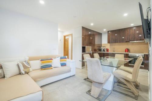 a living room with a white couch and a glass table at Casa Oliveira Gêres - by Proguest in Terras de Bouro